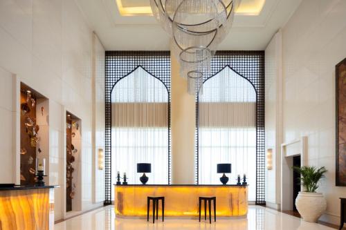 a lobby with a yellow table and some windows at The Ritz-Carlton, Bangalore in Bengaluru