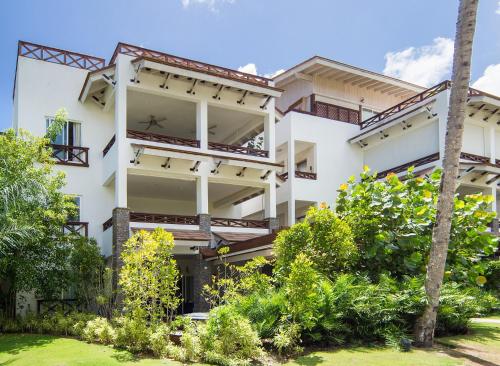 a white building with trees in front of it at Xeliter Balcones del Atlantico - Las Terrenas in Las Terrenas
