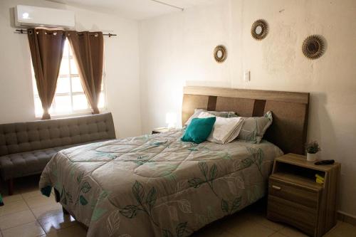 a bedroom with a large bed and a window at Depto 1 equipado x mitras cerca a imss 25 y a pasos del metro in Monterrey