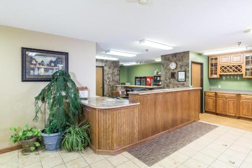 a large kitchen with a counter in a room at Governors Inn a Travelodge by Wyndham in Pierre