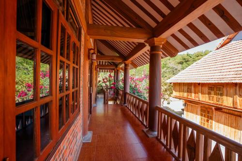 a balcony of a house with flowers at Bai Tu Long Mountain Resort in Hà Cái