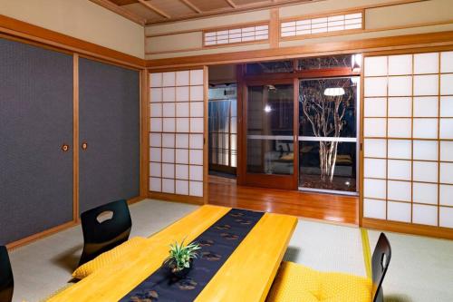 a room with a table and chairs and a window at villa the rise hakodate in Hakodate