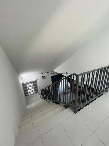 a staircase in a building with a white ceiling at Damai Centaurea Homestay Utp Uitm Seri Iskandar Perak in Seri Iskandar