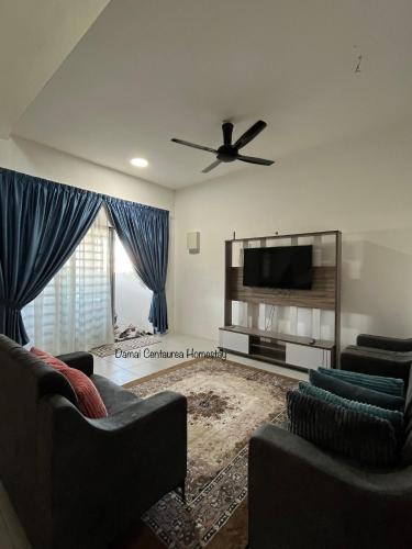 a living room with two couches and a flat screen tv at Damai Centaurea Homestay Utp Uitm Seri Iskandar Perak in Seri Iskandar