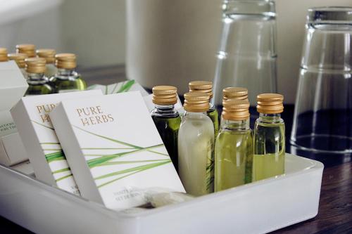 a tray with four bottles of oils on a table at Hotel Nihil Novi in Radom