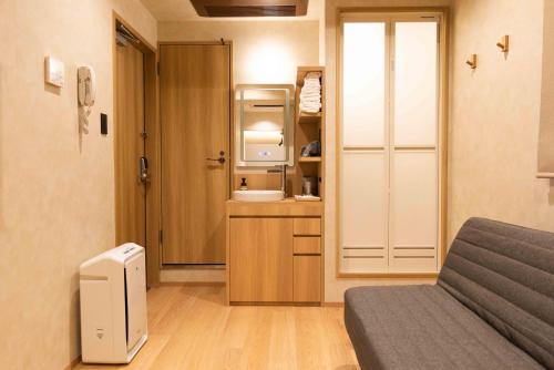 a small room with a bed and a television in it at Hotel Paul House in Tokyo