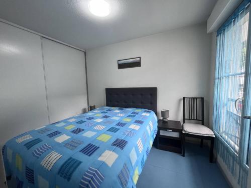 une chambre avec un lit, une chaise et une fenêtre dans l'établissement Charmant T2 à Cauterets avec parking et casier à skis - FR-1-812-29, à Cauterets