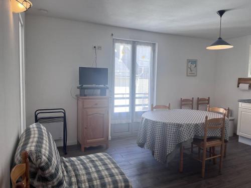 un salon avec une table et des chaises et une cuisine dans l'établissement Appartement famille à Cauterets avec balcon, casier à ski, idéal pour 4 personnes - FR-1-812-36, à Cauterets