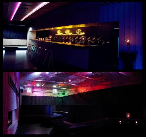 a room with a bar with purple and green lights at Hotel Nihil Novi in Radom