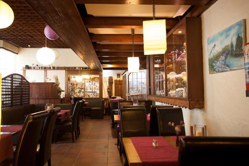 a dining room with tables and chairs in a restaurant at Hotel Haus Union in Oberhausen