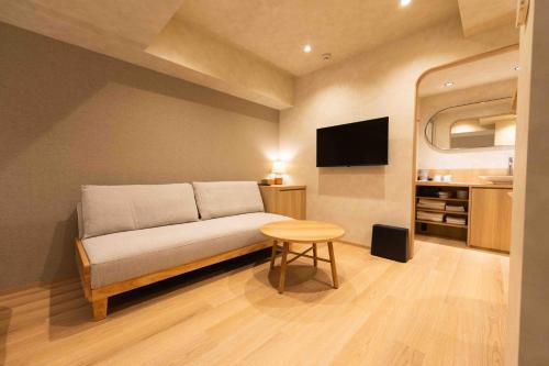 a living room with a couch and a table at Hotel Paul House in Tokyo