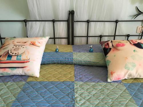 a bed with two pillows on top of it at B&B 8380 Saturnia Terme in Saturnia