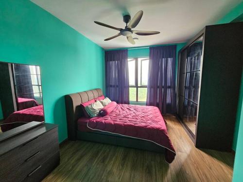 a bedroom with a bed and a ceiling fan at Gaia Residences Bandar Gamuda Gardens, Cozy Retreat with Mountain Views in Rawang