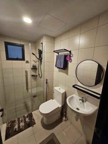 a bathroom with a shower and a toilet and a sink at Gaia Residences Bandar Gamuda Gardens, Cozy Retreat with Mountain Views in Rawang