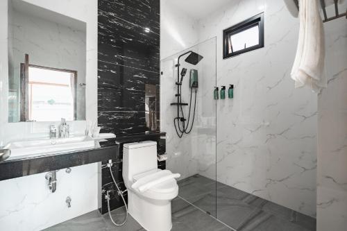 a bathroom with a toilet and a sink and a shower at Pakbia Pool Villa Aonang Krabi in Ao Nang Beach