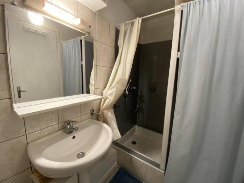 une salle de bain blanche avec un lavabo et une douche dans l'établissement Studio central avec balcon et parking à Cauterets - FR-1-812-117, à Cauterets