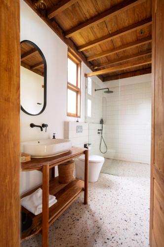 a bathroom with a sink and a toilet at Pool & Jungle View Family Room in Kaba-Kaba in Tabanan
