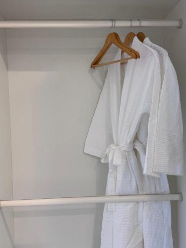 a closet with white towels hanging on a rack at Angkor Mansion & Residence in Siem Reap