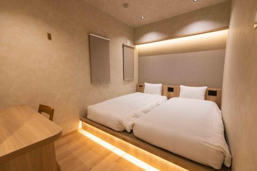 a bedroom with a large white bed in it at Hotel Paul House in Tokyo