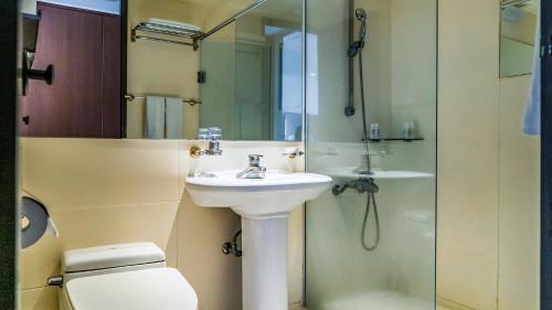 a bathroom with a toilet and a sink and a shower at Namhae Sports Park Hotel in Namhae