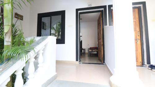 a hallway of a house with an open door at God's Gift Morjim in Morjim