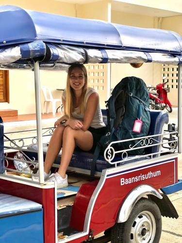 a girl sitting on the back of a golf cart at บ้านศรีสุธรรม 2 Baansrisuthum 2 in Surat Thani