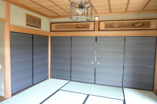 a garage with grey doors and a ceiling at Bob's house in Kameoka