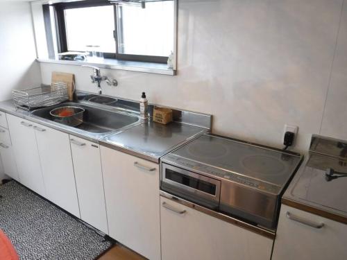 a small kitchen with a sink and a window at Bob's house in Kameoka