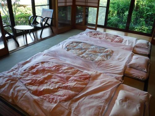 a large bed is covered with a blanket at Bob's house in Kameoka