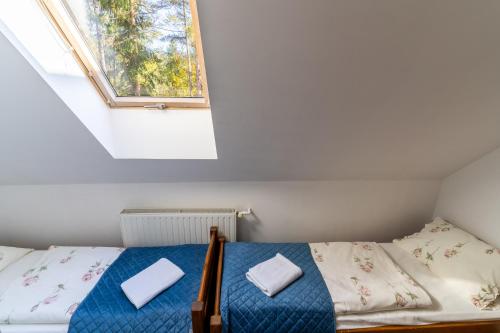 a small bedroom with a bed and a window at Base Camp Pieniny in Niedzica