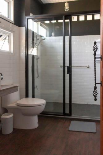 a bathroom with a shower with a toilet and a sink at liaw base house in Bangkok