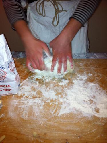 a person is kneading the dough on a table at Agriturismo Chieteno con piscina e AC- Cetona in Cetona