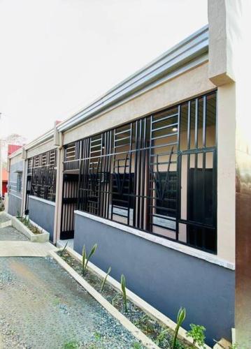 a building with windows on the side of a street at FYLL Homes Francheska Suite Calvario St Cavinti Town Proper in Cavinti