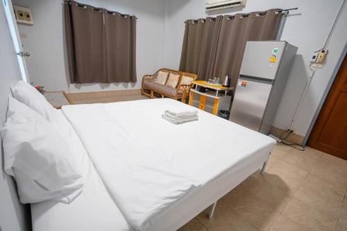 a hospital room with a bed and a refrigerator at Mitr Inn HuaHin Beach หาดหัวหิน in Hua Hin