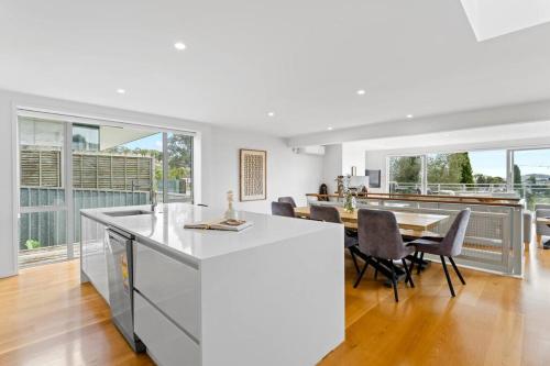 a kitchen and dining room with a table and chairs at Welcome to Luxury Living in CBD Near Mission Bay in Auckland