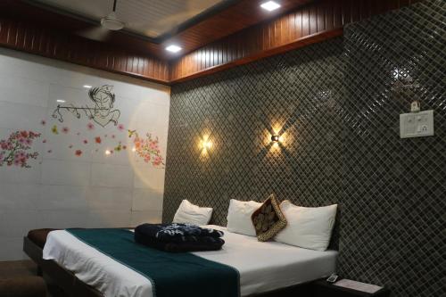 a bedroom with a bed and a wall at Hotel Geetanjali St Bus Stand Panvel in Panvel