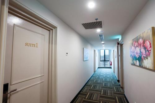 a corridor of a hallway with a door and a hallwayngth at The Host Hotel in Ipoh
