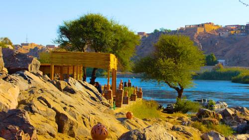 a small building on a hill next to a river at ASSINGAR camp in Jazīrat Suhayl