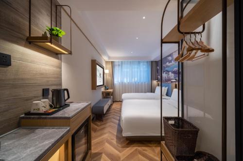 Una habitación de hotel con una cama y una cocina. en 景星王府井协和医院店, en Beijing