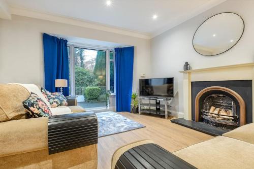 a living room with a couch and a fireplace at 4 double bedrooms Lux Villa in Malone Belfast in Belfast