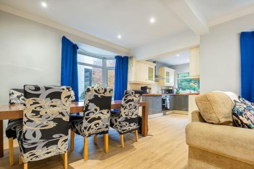 a kitchen and dining room with a table and chairs at 4 double bedrooms Lux Villa in Malone Belfast in Belfast