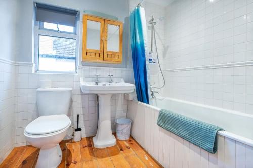 a bathroom with a toilet and a sink and a tub at 4 double bedrooms Lux Villa in Malone Belfast in Belfast