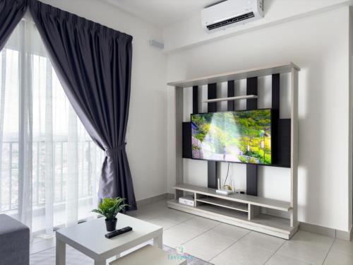 a living room with a flat screen tv on a wall at 3B2B 7 Pax - 5 min walk to MRT - F&B - Cheras in Kampong Baharu Cheras Batu Sa-Belas