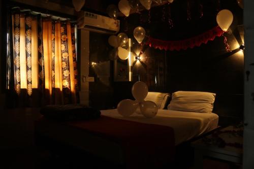 a room with a bed with balloons on it at Hotel Geetanjali St Bus Stand Panvel in Panvel