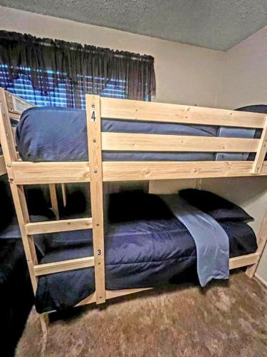 a wooden bunk bed in a room at Van Nuys Downtown Paradise in Los Angeles