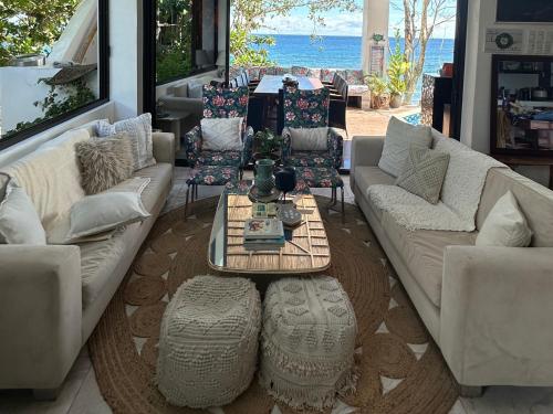 a living room with two couches and a coffee table at The French Villa-Santander Cebu in Santander