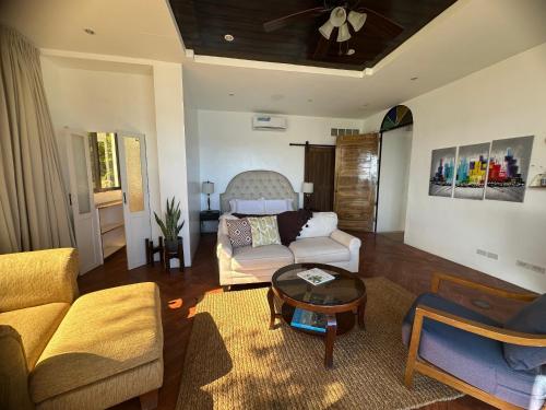 a living room with a couch and a table at The French Villa-Santander Cebu in Santander