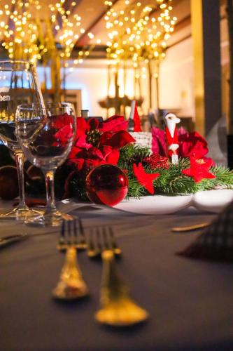 a table with a plate of food and wine glasses at Bodensee Hotel Storchen in Uhldingen-Mühlhofen