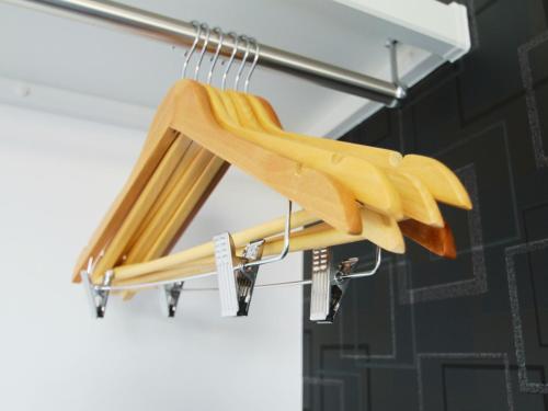a group of wooden hangers hanging on a rack at Casa Kikuchi in Kikuchi