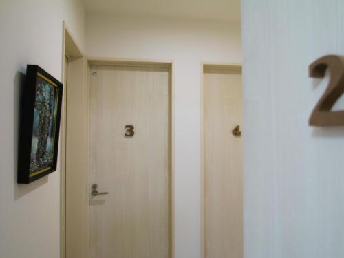 a hallway with a door with the number on it at Casa Kikuchi in Kikuchi